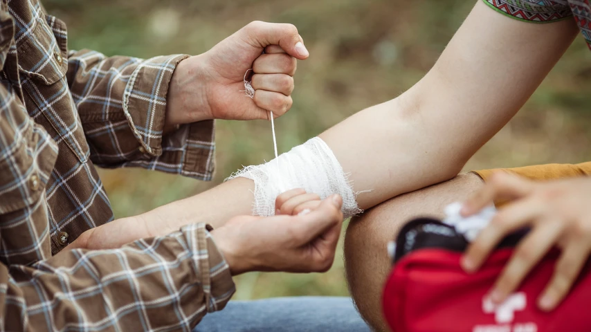 Bandaging a wound while hiking in nature